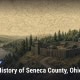 Fostoria News A historical illustration of Seneca County, Ohio with a fort, forest, and river.